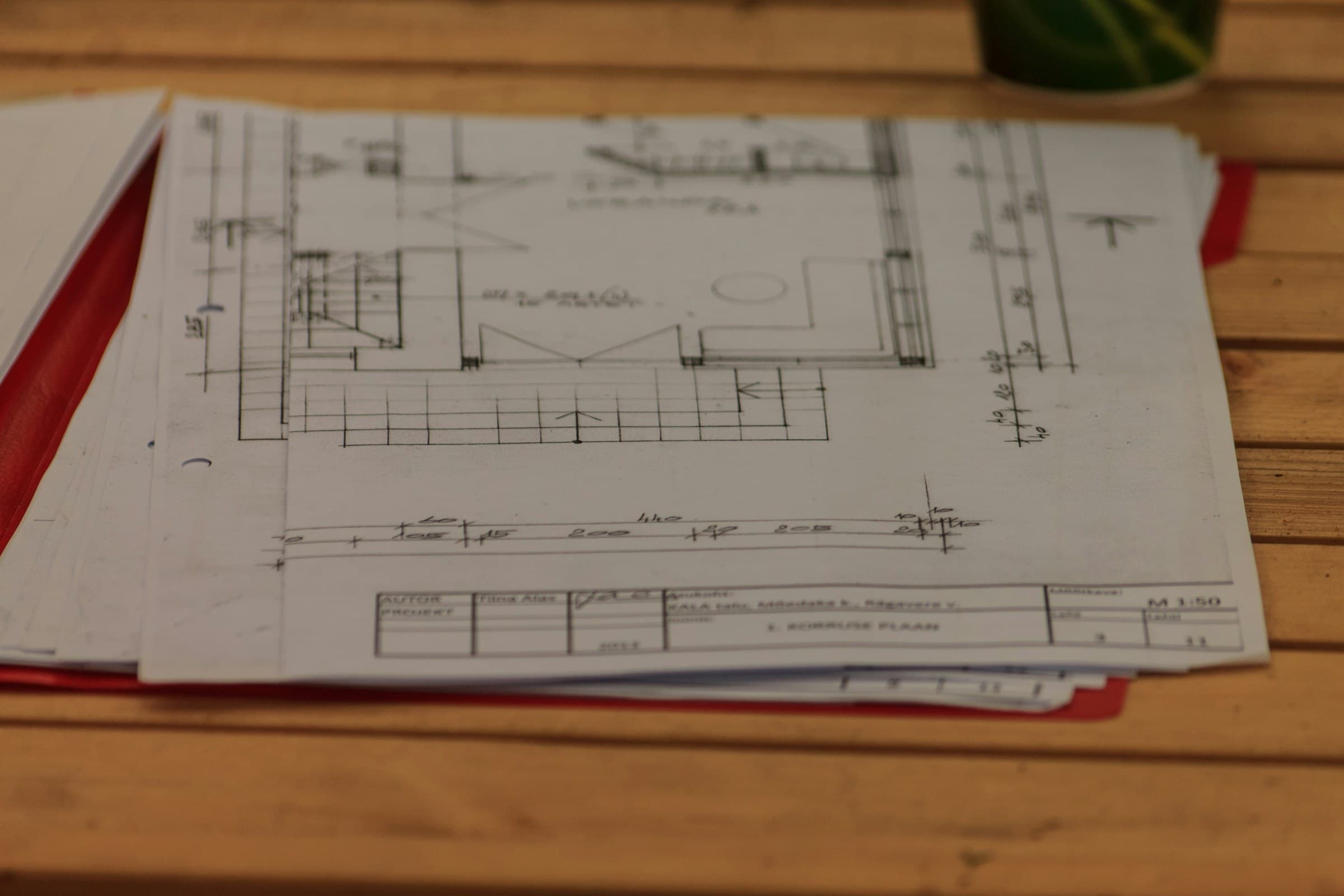 Architectural drawings on a wooden table