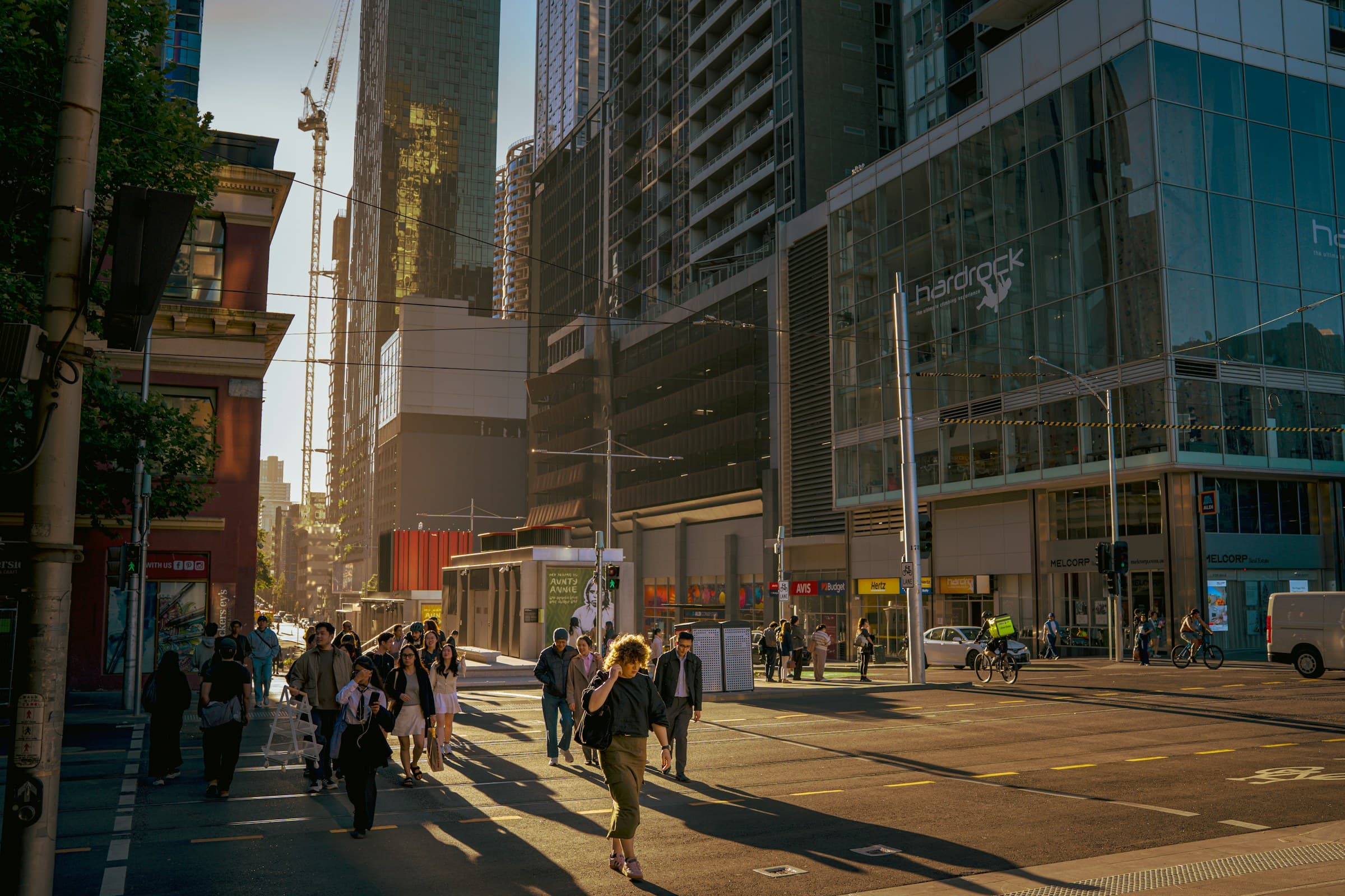 People crossing a sunlit city street